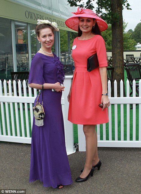 Elegant: A pair of glamorously dressed racegoers show off their ensembles