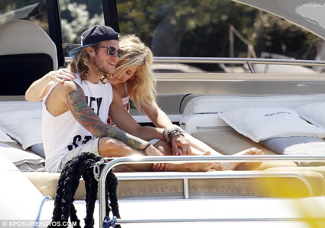 Can't keep her hands off him: The singer seemed to be wearing minimal make-up for the day as she enjoyed some well-earned rest with her boyfriend of over six months