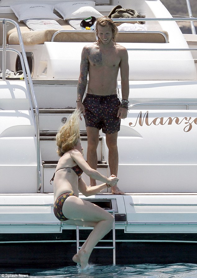 Alright for sun: Dougie smiled on as Ellie was about to splash in